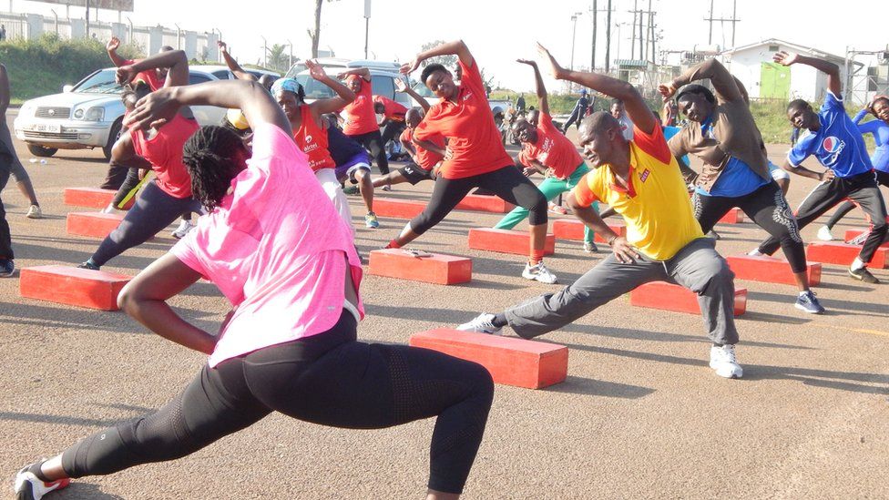 A woman stretching as part of her wellness journey.